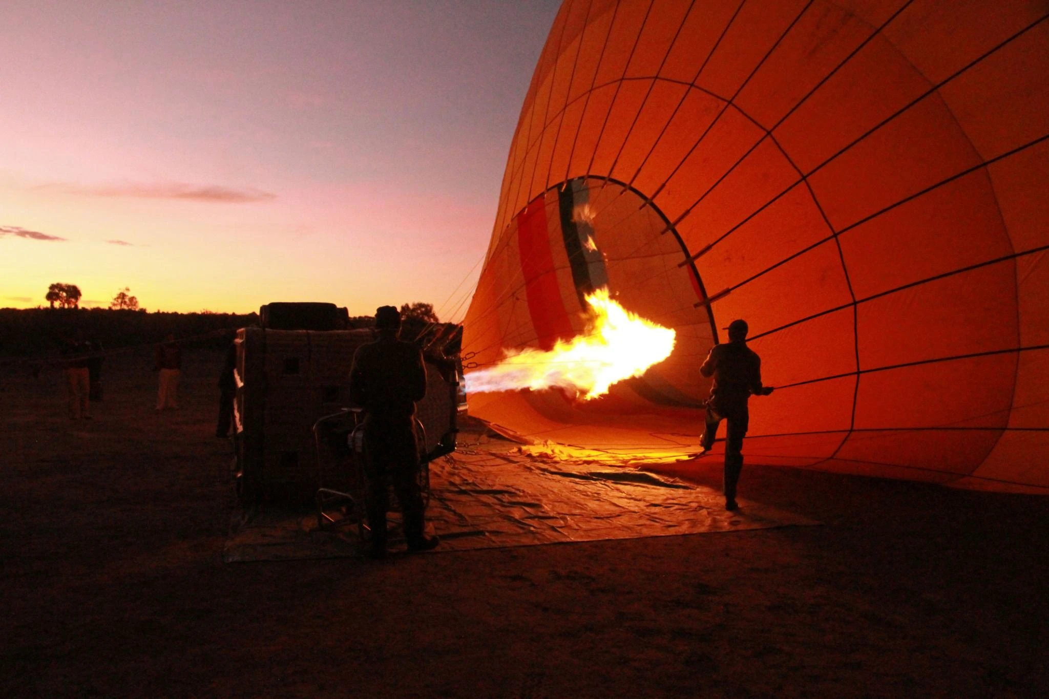 Hot air balloon being inflated in darkness before dawn ready for a safari in maasai mara national reserve kenya